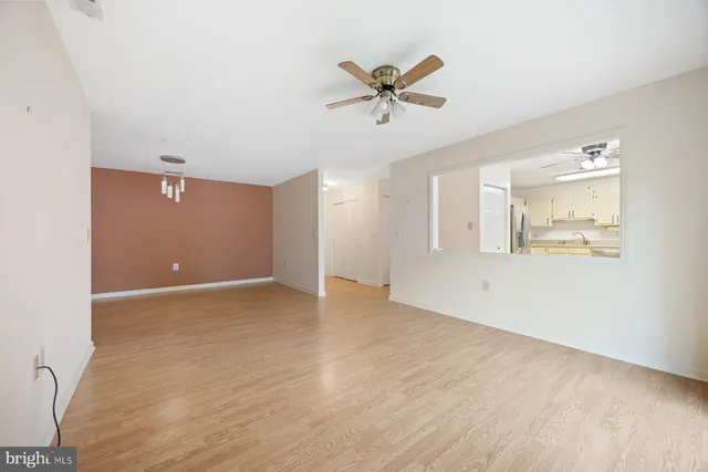 a view of a livingroom with a hardwood floor and a ceiling fan
