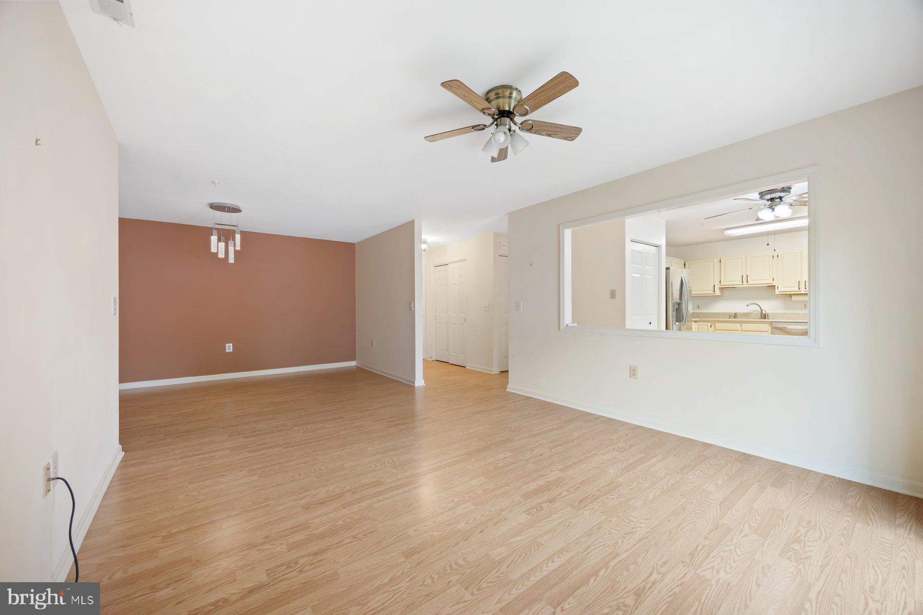 3901 Darleigh Road, Unit 1E Nottingham, MD 21236 - Photo 7 of 27 a view of a livingroom with a hardwood floor and a ceiling fan