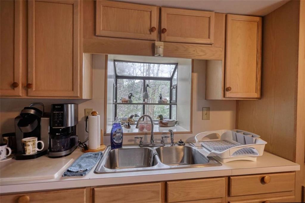 1665 County Line Road Mansfield, GA 30055 - Photo 23 of 74 a kitchen with a sink and cabinets