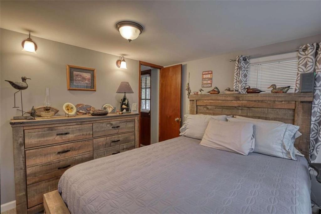 1665 County Line Road Mansfield, GA 30055 - Photo 26 of 74 a bedroom with a large bed and a dresser