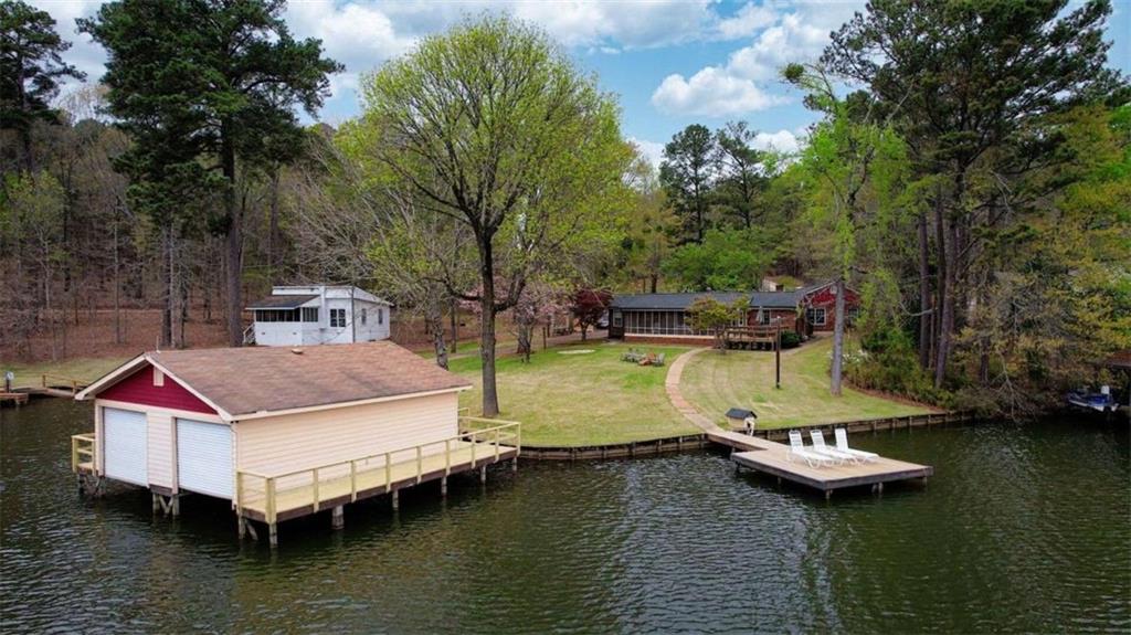 1665 County Line Road Mansfield, GA 30055 - Photo 3 of 74 a view of a lake with a house