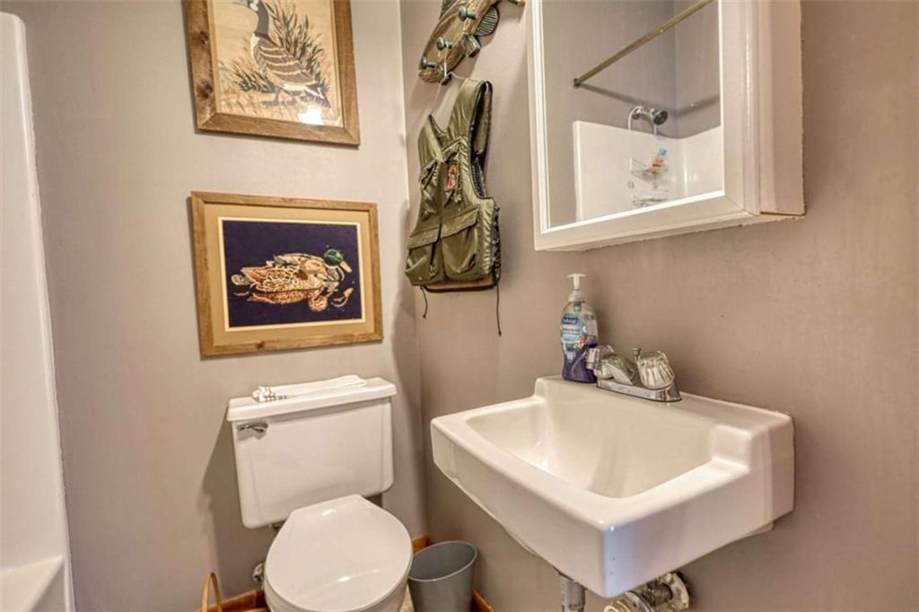 1665 County Line Road Mansfield, GA 30055 - Photo 32 of 74 a bathroom with a toilet sink and mirror