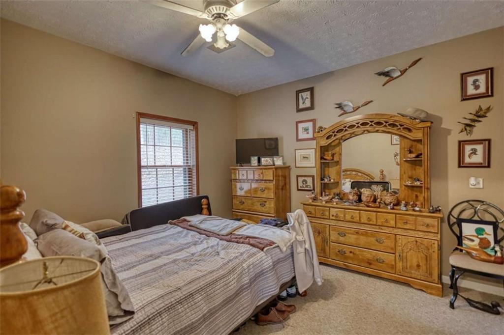 1665 County Line Road Mansfield, GA 30055 - Photo 34 of 74 a bedroom with a bed and a mirror on the dresser