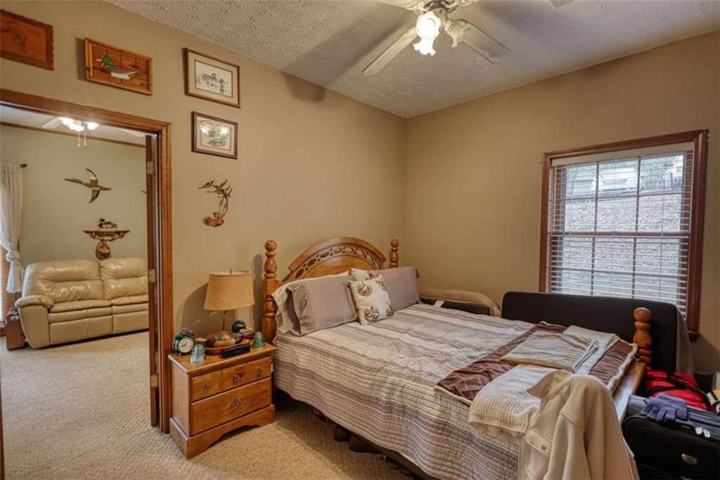 1665 County Line Road Mansfield, GA 30055 - Photo 35 of 74 a bedroom with a bed couch and window