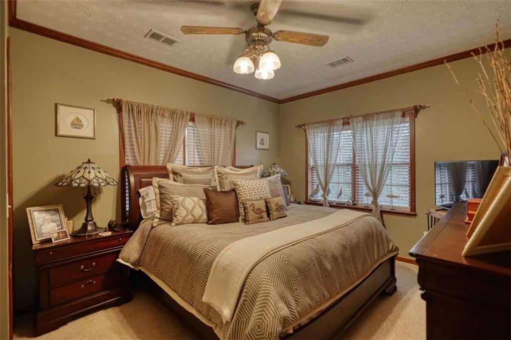 1665 County Line Road Mansfield, GA 30055 - Photo 46 of 74 a bedroom with a bed and a dresser with the shoe rack