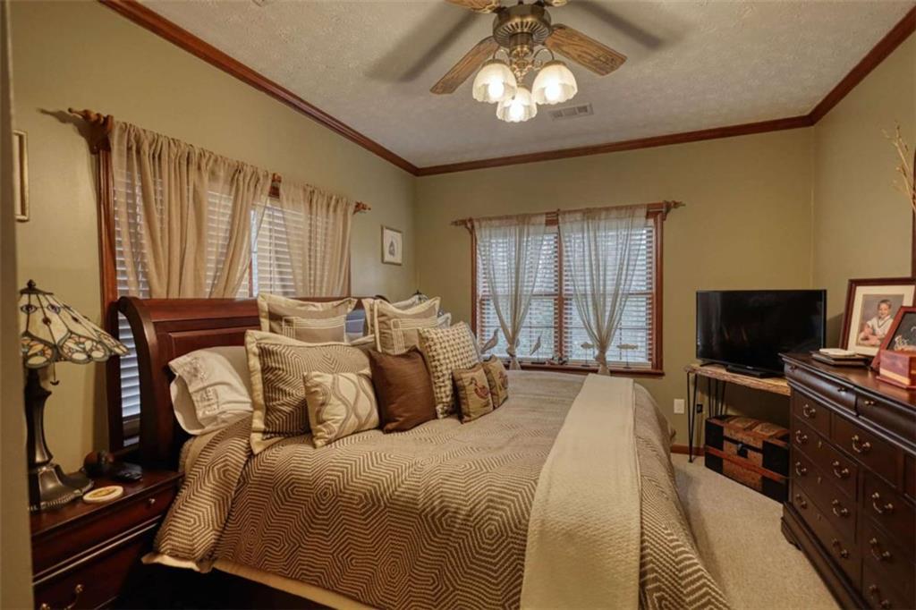 1665 County Line Road Mansfield, GA 30055 - Photo 47 of 74 a bedroom with a bed and a flat tv screen on dresser