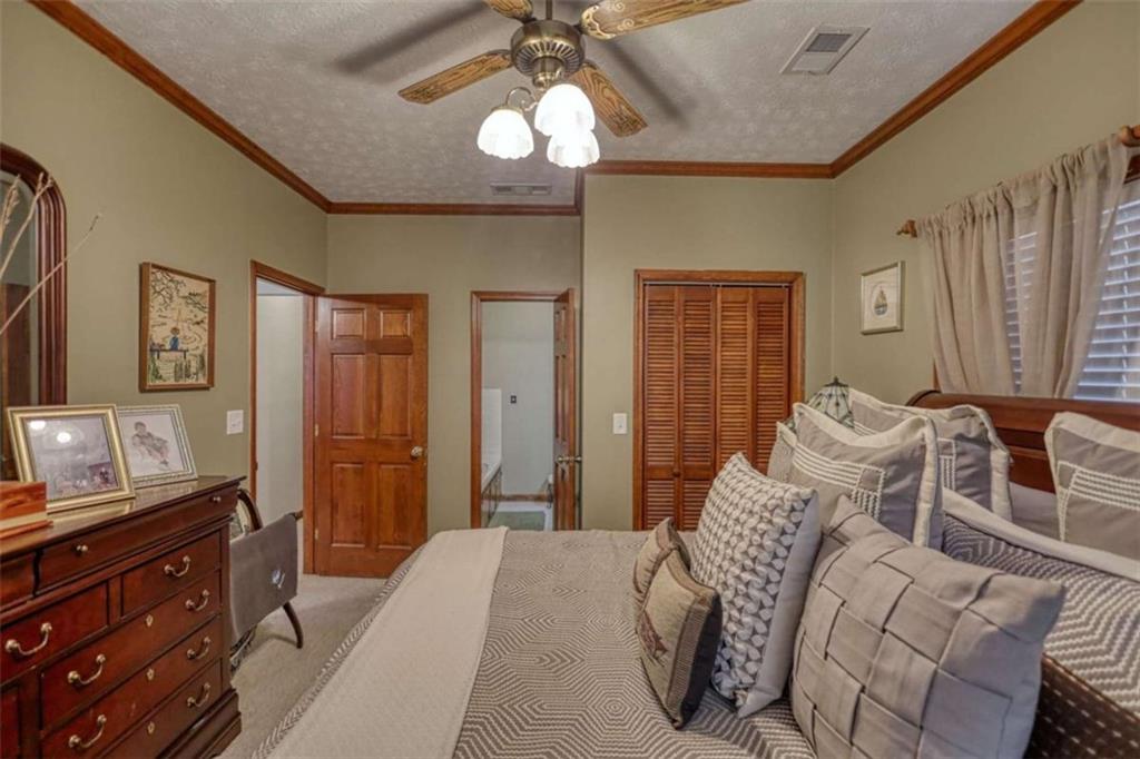 1665 County Line Road Mansfield, GA 30055 - Photo 48 of 74 a bedroom with a bed and a chandelier