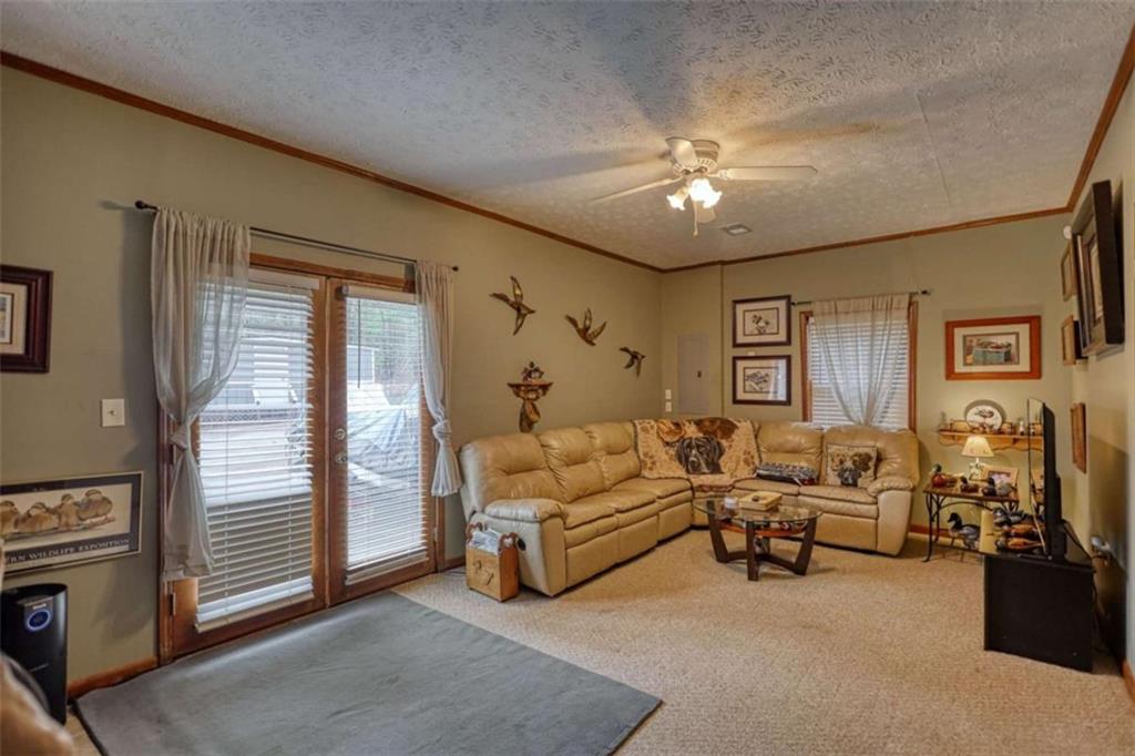1665 County Line Road Mansfield, GA 30055 - Photo 52 of 74 a living room with furniture and a chandelier