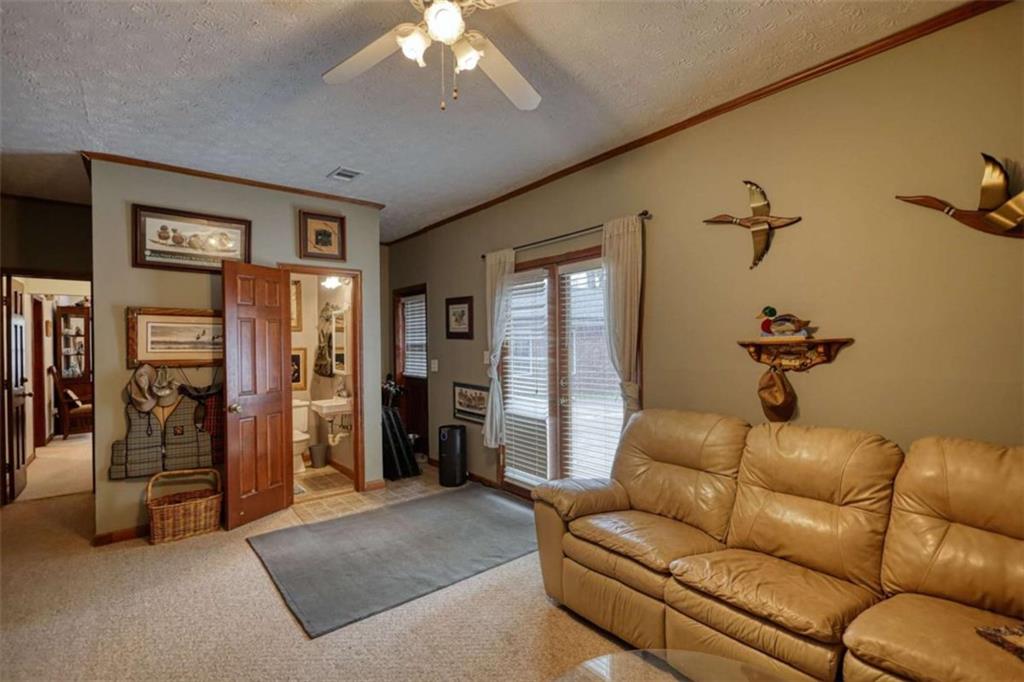 1665 County Line Road Mansfield, GA 30055 - Photo 53 of 74 a living room with furniture and a chandelier