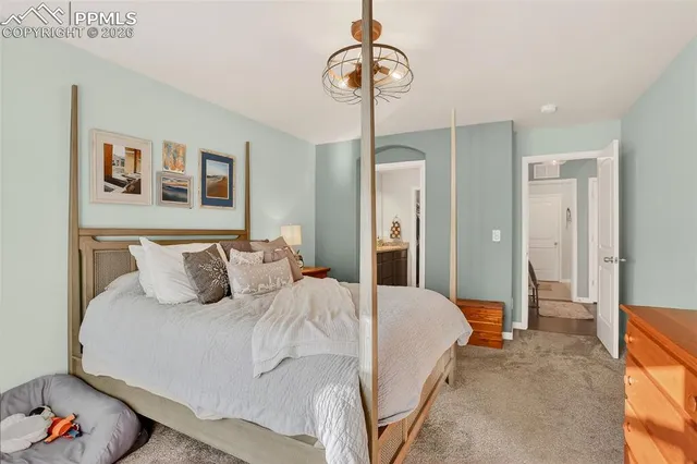 a bedroom with a bed and a chandelier