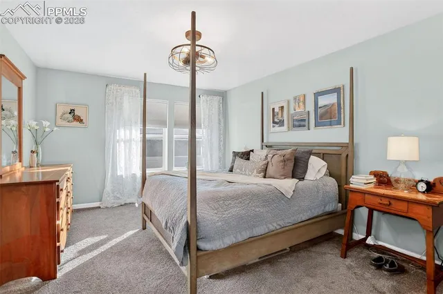 a bedroom with a bed and a table in it