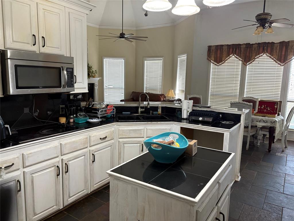 709 Timberview Court North Fort Worth, TX 76112 - Photo 5 of 14 a kitchen with stainless steel appliances granite countertop a sink a stove and a microwave