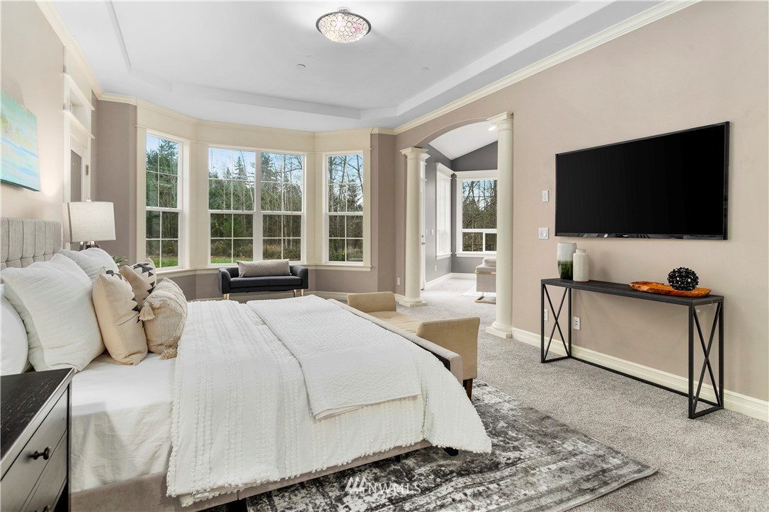 20630 Southeast 216th Street Maple Valley, WA 98038 - Photo 20 of 40 a spacious bedroom with a bed and a flat screen tv