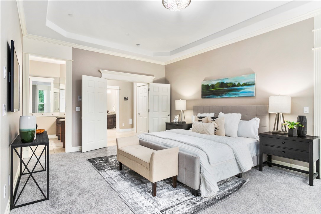 20630 Southeast 216th Street Maple Valley, WA 98038 - Photo 21 of 40 a bedroom with a bed and a chandelier