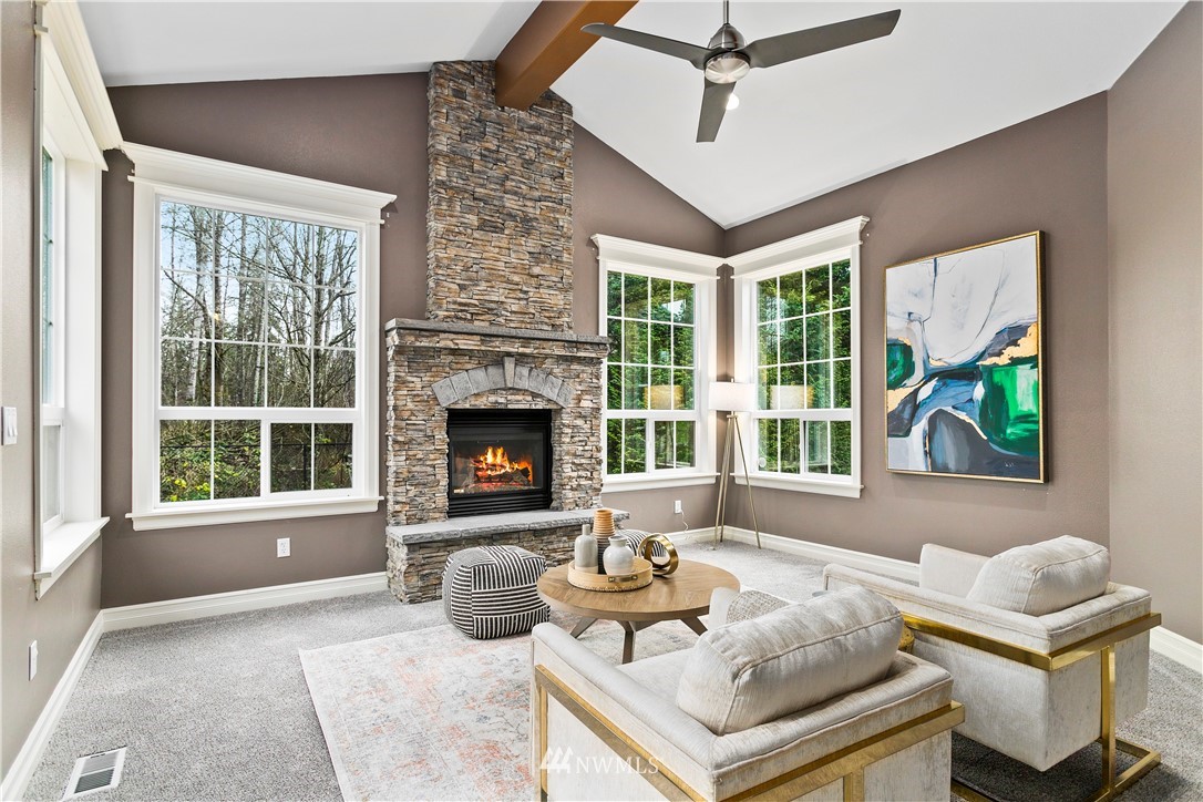 20630 Southeast 216th Street Maple Valley, WA 98038 - Photo 22 of 40 a living room with furniture and a fireplace