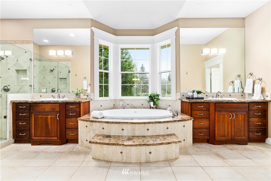 20630 Southeast 216th Street Maple Valley, WA 98038 - Photo 25 of 40 a spacious bathroom with a tub sink and mirror