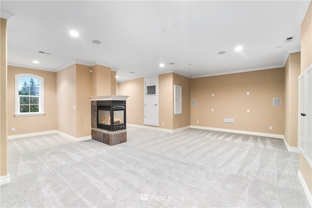 20630 Southeast 216th Street Maple Valley, WA 98038 - Photo 30 of 40 an empty room with windows and fireplace