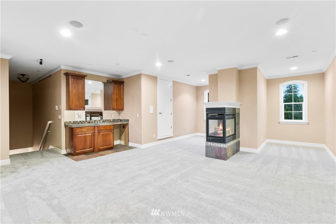 20630 Southeast 216th Street Maple Valley, WA 98038 - Photo 31 of 40 a view of kitchen with stainless steel appliances kitchen island a large counter top and a refrigerator