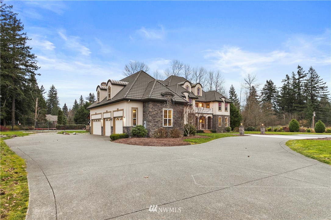 20630 Southeast 216th Street Maple Valley, WA 98038 - Photo 34 of 40 a front view of a house with a yard and garage