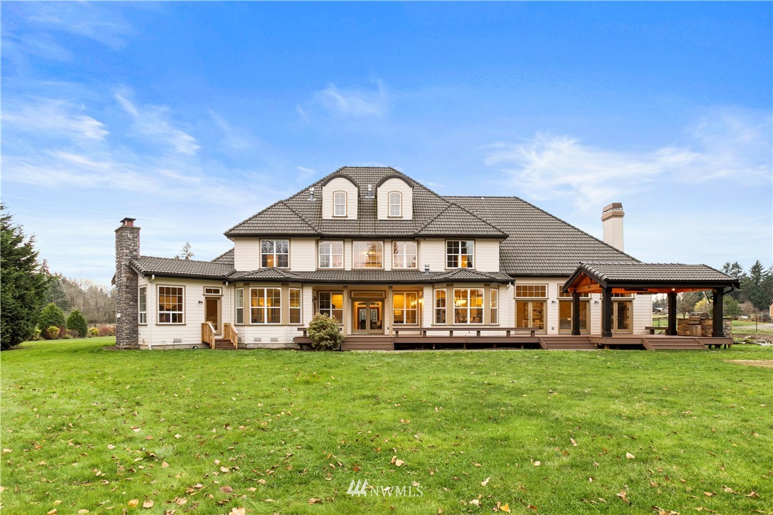 20630 Southeast 216th Street Maple Valley, WA 98038 - Photo 39 of 40 a front view of a house with a yard table and chairs