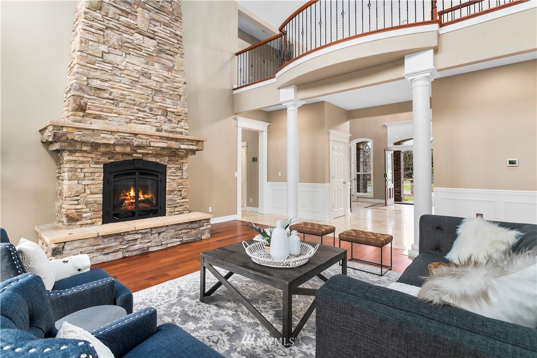 20630 Southeast 216th Street Maple Valley, WA 98038 - Photo 7 of 40 a living room with furniture and a fireplace
