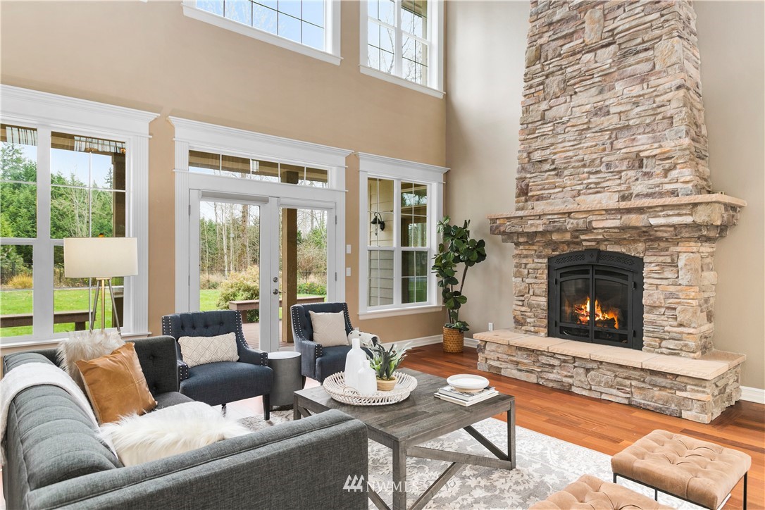 20630 Southeast 216th Street Maple Valley, WA 98038 - Photo 8 of 40 a living room with furniture and a fireplace