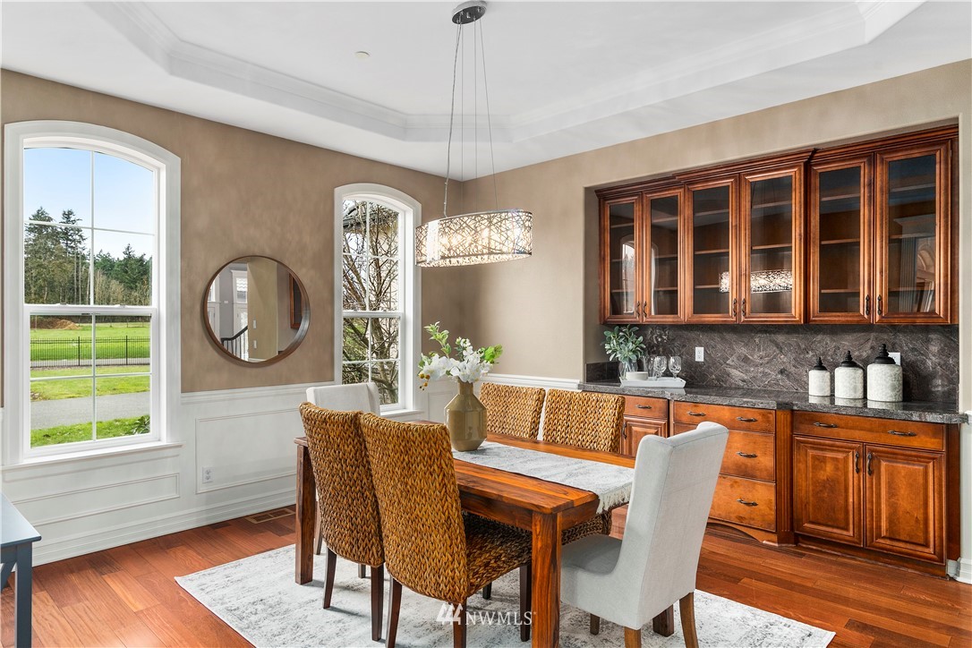 20630 Southeast 216th Street Maple Valley, WA 98038 - Photo 9 of 40 a dining room with furniture a window and wooden floor