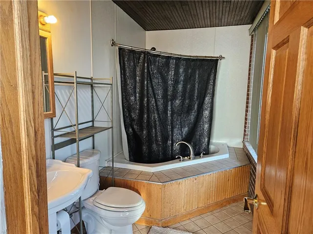 a bathroom with a toilet a sink and a mirror