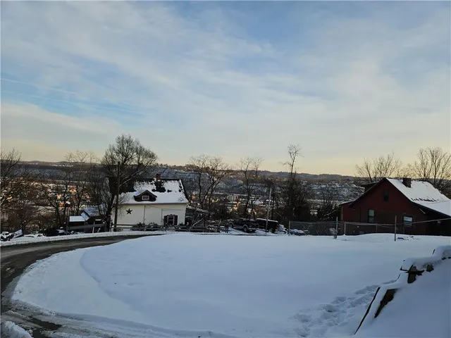 a roof deck with table and chairs