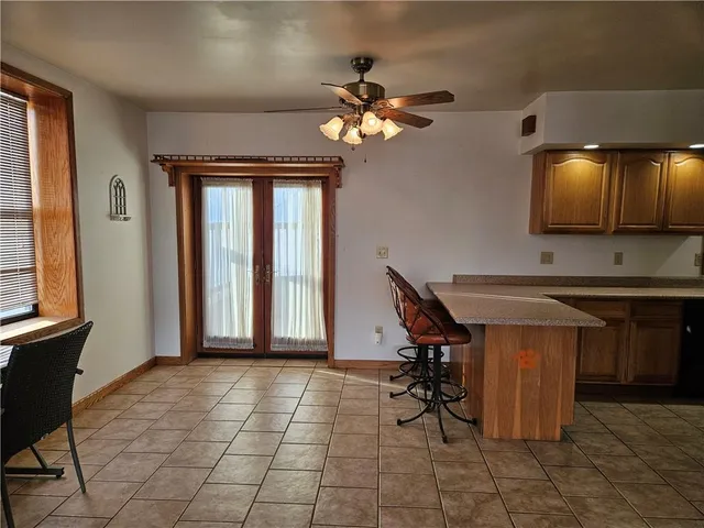a view of a dining room with furniture and a chandelier