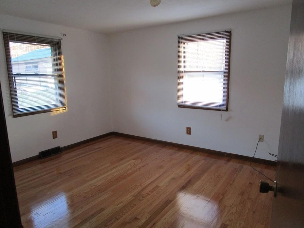103 Garnet Street Springfield, MA 01129 - Photo 12 of 16 a view of an empty room with wooden floor and a window