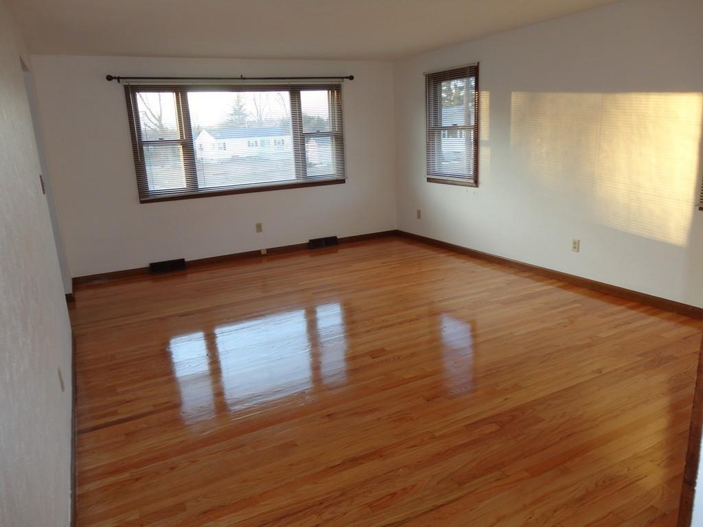 103 Garnet Street Springfield, MA 01129 - Photo 13 of 16 a view of an empty room with wooden floor and a window