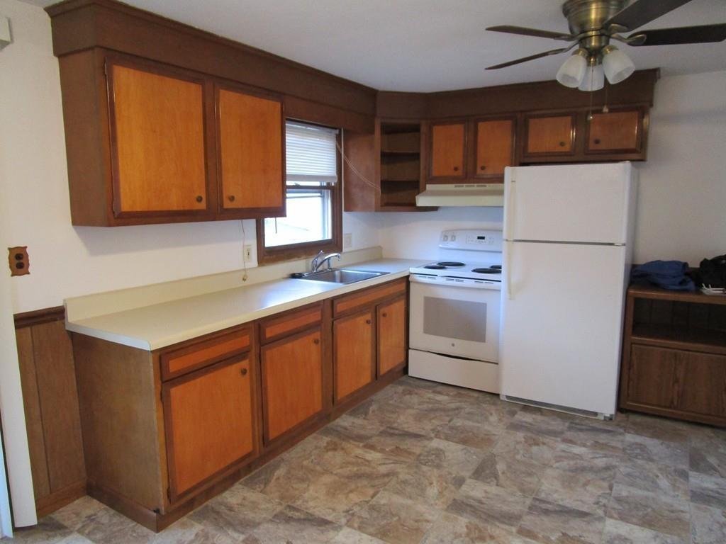 103 Garnet Street Springfield, MA 01129 - Photo 5 of 16 a kitchen with a stove a refrigerator and a sink