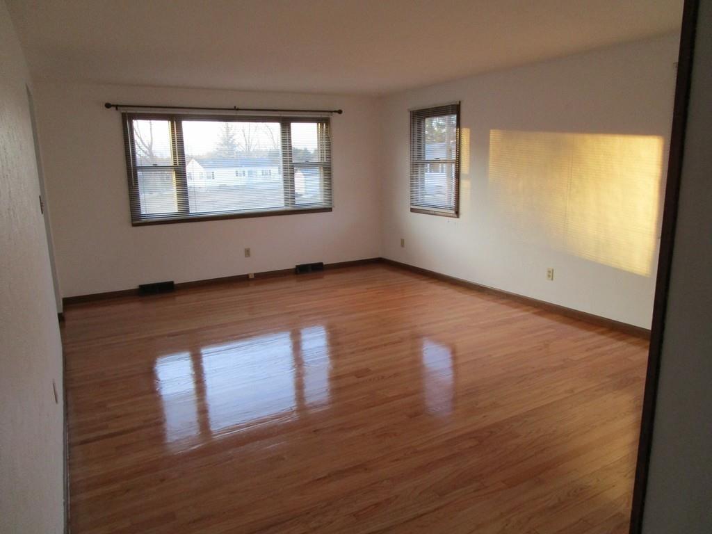 103 Garnet Street Springfield, MA 01129 - Photo 9 of 16 a view of an empty room with wooden floor and a window
