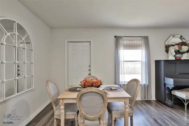 a dining room with furniture a window and wooden floor