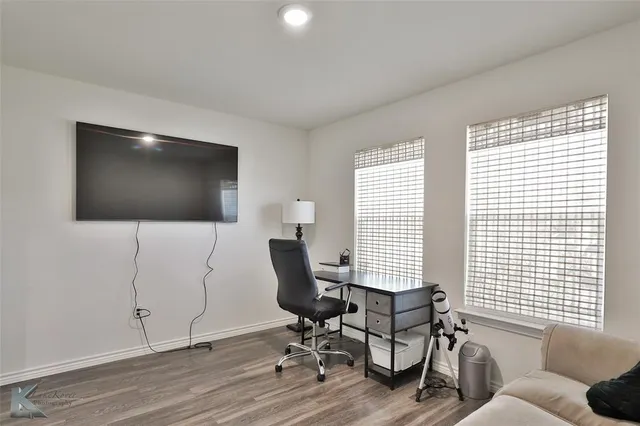 a view of a livingroom with workspace and a window