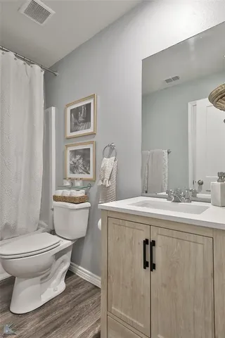 a bathroom with a toilet sink and shower