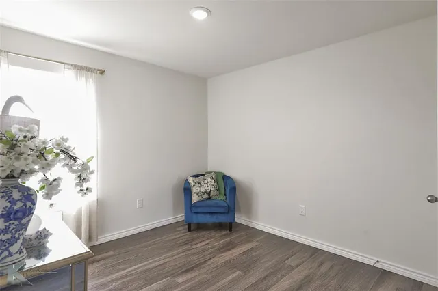 a view of a room with wooden floor and a window