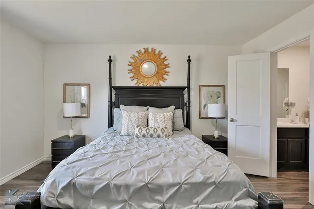 a bedroom with a bed and a lamp on table