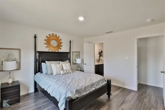 a bedroom with a bed and a painting on the wall