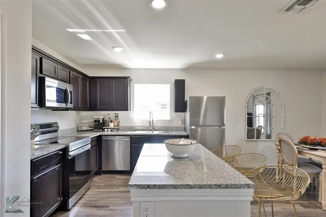 a large kitchen with granite countertop lots of counter top space