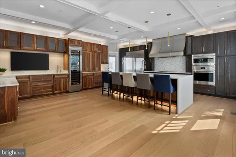 a large kitchen with stainless steel appliances lots of counter space and breakfast area