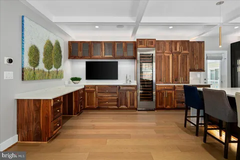 a kitchen with stainless steel appliances microwave stove refrigerator and dining table