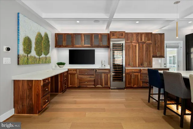 a kitchen with stainless steel appliances microwave stove refrigerator and dining table