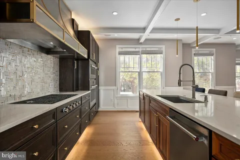 a kitchen with granite countertop a sink and wooden cabinets