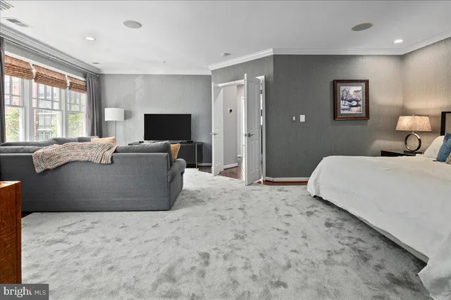 a bedroom with a large bed and a flat screen tv