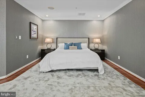 a bedroom with a bed and painting on the wall