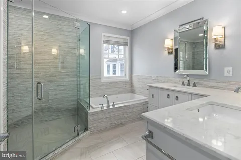 a bathroom with a tub sink shower and a mirror