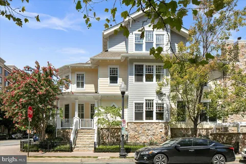 a front view of a residential apartment building with a yard