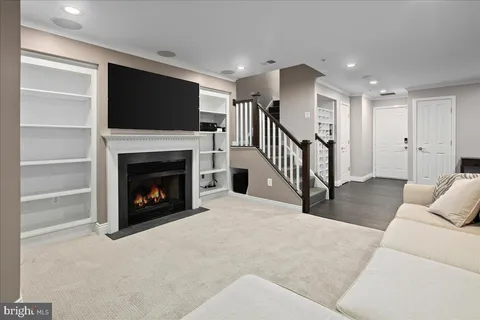 a living room with a fireplace and a flat screen tv